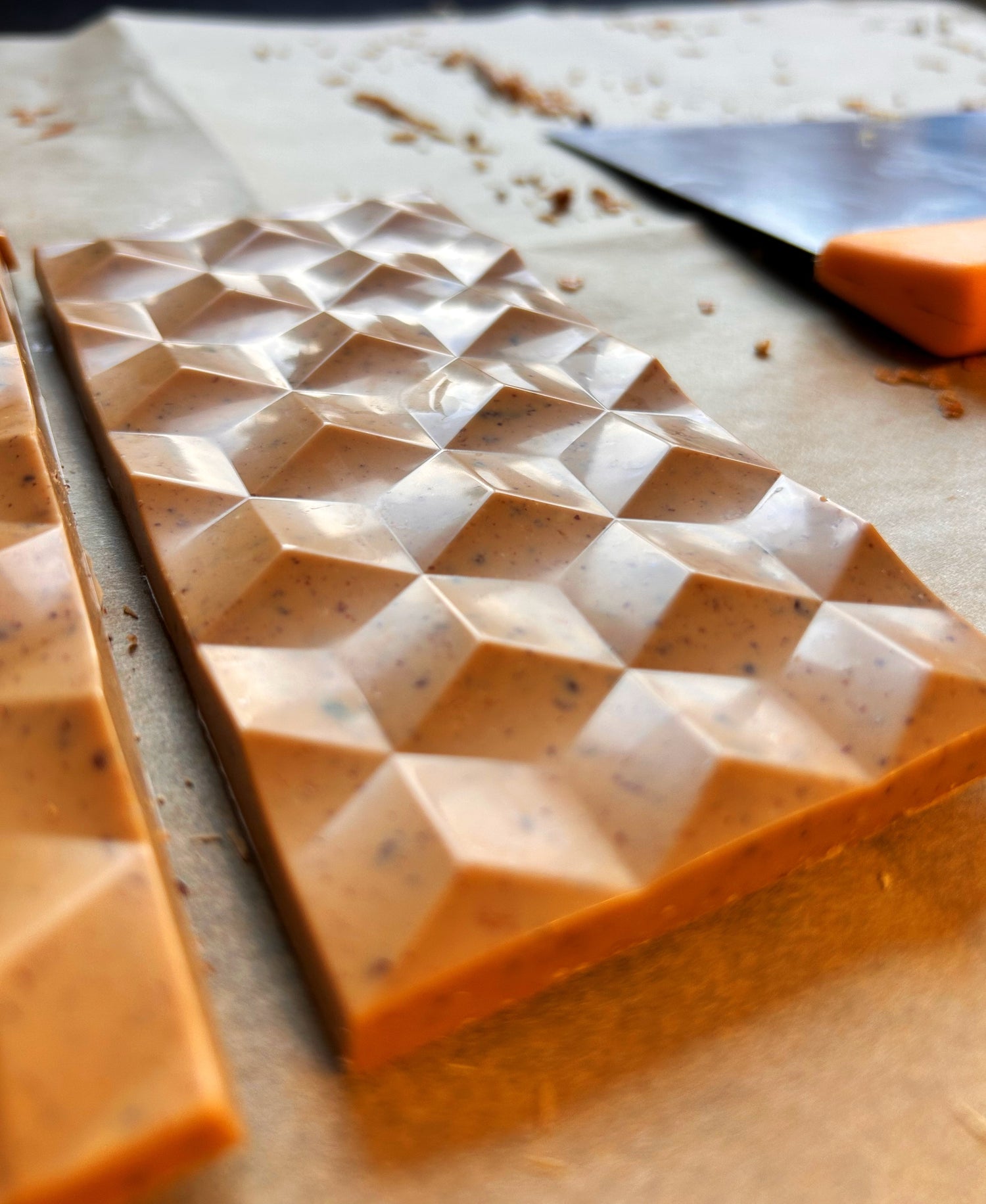 Chocolate bar with geometric pattern on a wooden surface